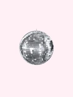 a silver disco ball on a pink background