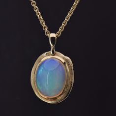 Details: 18k Yellow Gold Opal, 7.61 carat total weight Measurements: 20" chain included Finely crafted in New York, New York. Audrius Krulis' Biography & Collection can be found here. Please contact us for resizing options, special order inquiries, or any other questions. Formal Round Cabochon Necklaces, Formal Oval Link Necklace, Hallmarked, Formal Oval Link Necklace Hallmarked, Formal Oval Link Hallmarked Necklace, Formal Cabochon Pendant Necklace, Formal Hallmarked Oval Link Necklace, Heirloom Style Yellow Gold Cabochon Jewelry, Antique Yellow Gold Necklace With Cabochon, Exquisite Jewelry With Oval Cabochon And Polished Finish