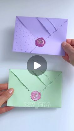 two hands holding an origami envelope