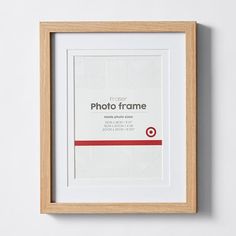 a wooden frame hanging on the wall with a white and red border around it that says photo frame