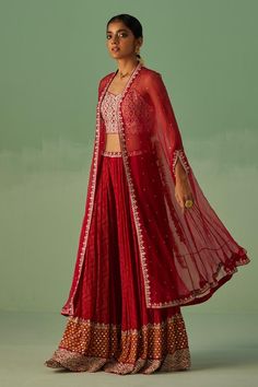 Red cape with floral embellished border. Paired with an inner blouse with mirror, dabka and beads embroidery. Comes along with a sharara with geometric print and embroidered waistband.
Components: 3
Pattern: Print, Embroidery
Type Of Work: Mirror, Dabka, Beads, Geometric, Floral
Neckline: Blouse: Sweetheart Neck
Sleeve Type: Blouse: Sleeveless
Fabric: Cape: Organza, Blouse: Dull Bosky, Sharara: Bamboo Georgette
Color: Red
Other Details: 
Length: 
Cape: 50 inches
Blouse: 15 inches
Sharara: 44 inc Festive Front Open Georgette Set, Traditional Front Open Palazzo Set For Party, Party Sets With Zari Work And Front Open Design, Front Open Party Sets With Zari Work, Party Sets With Front Open Design And Zari Work, Party Sets With Front Open And Zari Work, Festive Red Set With Sheer Dupatta, Red Mirror Work Palazzo Set For Wedding, Red Sharara With Sheer Dupatta For Celebration