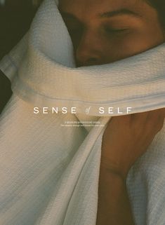 a woman wrapped in white cloth covering her face with the words sense of self on it