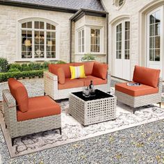 an outdoor living room with orange and gray furniture