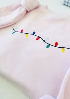 Embrace the joy of the holiday season with our Christmas Lights Embroidered Sweatshirt. This beautifully embroidered piece combines comfort and festive flair, making it the perfect addition to your winter wardrobe! Unmatched Comfort: Made from a cozy blend of 50% cotton and 50% polyester, this sweatshirt is designed to keep you warm and comfortable all season long. Stylish Design: Featuring vibrant, high-quality heat transfer embroidery, this shirt captures the essence of Christmas and adds a ch Hand Embroidered Christmas Sweatshirt, Christmas Embroidery Sweatshirts, Embroidered Christmas, Christmas Catalogs, Embroidery Sweatshirt, Christmas Embroidery, Embroidered Sweatshirt, Holiday Lights, Embroidered Sweatshirts