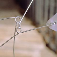 a close up view of a wire fence with a piece of metal attached to it