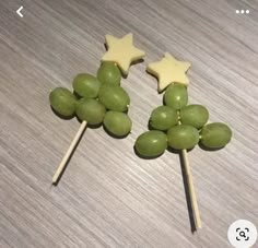 two green grapes and stars on top of toothpicks