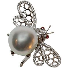 Beautiful Bumble Bee pin, set with approximately 0.50ctw in G/VS diamonds, enhancing the wings and body, a 15mm White South Sea Pearl and two Ruby eyes; 18k white gold; pin measures approx. 40.5mm x 24.25mm and weighs approx. 14.20gm. A Classic and Timeless Beauty! Bee Brooch, Insect Jewelry, Sea Pearl, Ruby Jewelry, Sea Pearls, South Sea Pearls, Ruby Diamond, Pearl Diamond, Tahiti