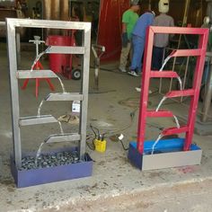 two metal frames with wires connected to them sitting on the ground next to each other