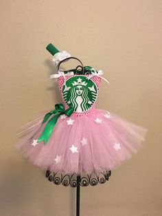 a pink tutu skirted dress with a starbucks cup on the front and green bow at the top