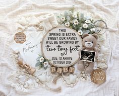 a teddy bear surrounded by other items on a white blanket with the words spring is extra sweet our family will be growing by two tiny feet due to arrive