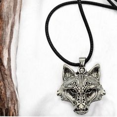 a necklace with a wolf head on it