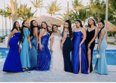 a group of women standing next to each other near a pool