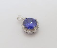 Vintage Sterling Silver Tanzanite & White Topaz Halo Pendant...Marked 925...Total of weights 3.1grams...Measure of stone center 10MM...Measure of Pendant H 6/8'' W 1/2''...It's in very good condition. Silver Tanzanite Round Stone Jewelry, Silver Tanzanite Gemstones With Brilliant Cut, Tanzanite Pendant, Halo Pendant, Blue Violet, White Topaz, Vintage Sterling Silver, Pendant Necklaces, Semiprecious Stones