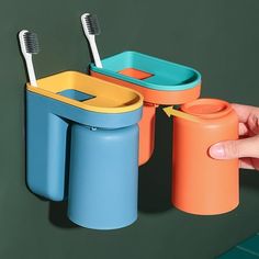 the toothbrush holder is designed to look like it has two cups and one container