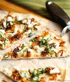 four slices of pizza sitting on top of a cutting board