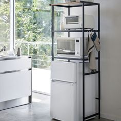 a white refrigerator freezer sitting next to a window