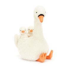 a white duck with two babies sitting on it's back and facing the camera