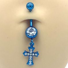 a blue belly ring with a cross on it