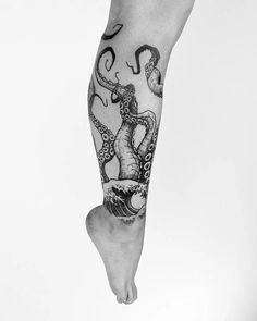 a man's leg with an octopus tattoo on it and the legs are black and white