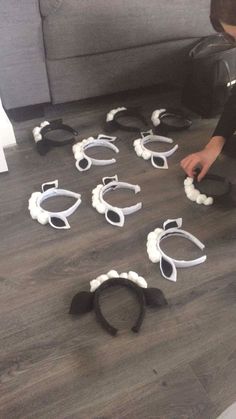 a young boy is playing with hair clips on the floor in front of a couch