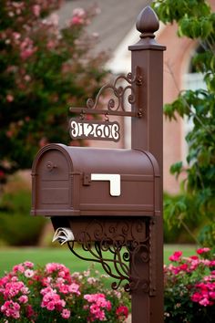 a mailbox in the middle of some flowers