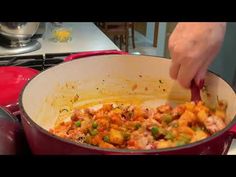 a person stirring food in a pot on the stove