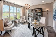 a living room filled with furniture and windows