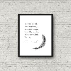 a white brick wall with a black frame hanging on it and a quote written in cursive writing