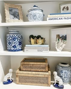 the shelves are filled with vases, books and other decorative items in blue and white