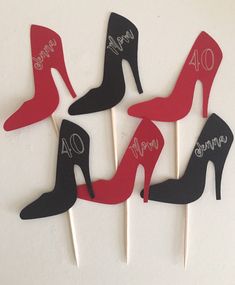 four red and black high heel cupcake toppers with the number forty on them