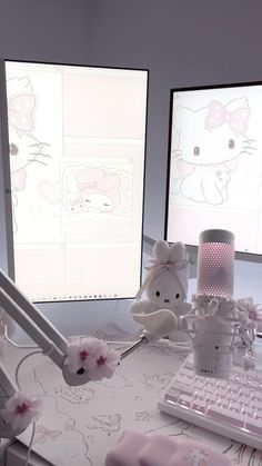 there are two computer screens with hello kitty drawings on them, one is pink and the other is white