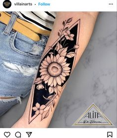 a sunflower tattoo on the left arm