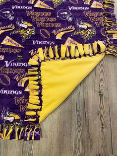 the minnesota state university blanket is laying on top of a wooden floor