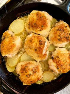 chicken and potatoes cooking in a cast iron skillet