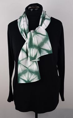 This one of kind shibori scarf is hand dyed in a forest green professional fiber reactive dye. Approximately 10"X57" this scarf is made of 100% rayon. Shibori is the traditional art of Japanese shaped resist dye. Using itajime shibori techniques, the fabric is carefully folded and then bound with wooden shapes to resist the dye, creating the lines and open areas of white.  The art of shibori brings the synergy of fabric, folding, and dyeing together such that each item emerges from the dye with its own unique characteristics. Itajime shibori results in blurred line around the edges of the wooden shapes and is reminiscent of watercolors. After careful folding and binding of the wooden shapes, this piece is dipped 5 times in the forest green fiber reactive dye to create the beautiful color o Green Hand Dyed Bohemian Scarf, Casual Green Handmade Scarf, Itajime Shibori, Shibori Scarf, Fabric Folding, Hand Dyed Scarves, Shibori Techniques, Wooden Shapes, Unique Characteristics