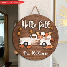 a wooden sign that says hello fall the williams family car is parked in front of it