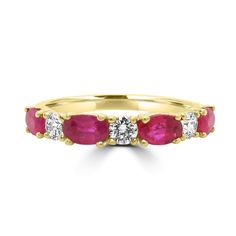 a yellow gold ring with three ruby stones on the side and one diamond in the middle