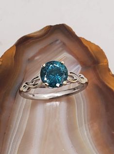 a blue ring sitting on top of a shell