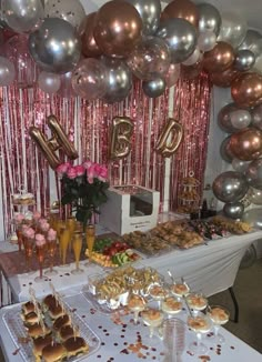 a table topped with lots of desserts and confetti on top of it