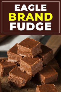 a pile of fudge brownies sitting on top of a wooden cutting board