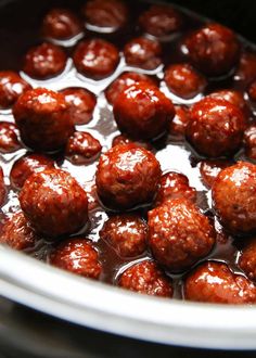 meatballs are being cooked in the oil and then coated with brown sauce, ready to be eaten