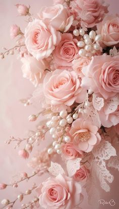 a bouquet of pink roses and baby's breath on a pink background with pearls