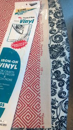 a package of iron - on vinyl sitting on top of a tablecloth covered in fabric