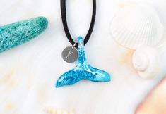 "Beautiful and delicate necklace in the shape of a dolphin tail made of resin and perfect to wear all year round as a sign of your enormous love for sea life, dolphins and whales. This small unisex ocean choker it is light and is available in ten different colors. This piece of jewelry is a real gift for yourself or your loved ones, if you are a surfer or simply love this beautiful animal, this is your pendant. This pretty whale tail is made of resin dyed blue and with a reef effect. Each piece Ocean-inspired Adjustable Necklace As A Gift, Adjustable Ocean-inspired Necklace For Gifts, Adjustable Ocean-inspired Necklace For Gift, Adjustable Ocean-inspired Round Pendant Jewelry, Adjustable Ocean-inspired Charm Necklace With Lobster Clasp, Ocean-inspired Adjustable Charm Necklace Gift, Dolphin Tail, Surfer Jewelry, Dolphin Jewelry