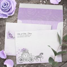 two envelopes with purple flowers on them and one has a horse drawn carriage in the middle