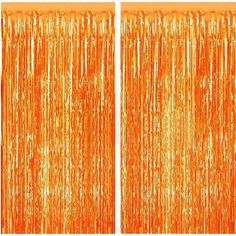 two orange tinsel curtains with fringes hanging from the top, and one on the bottom