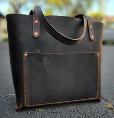 Hand Stitched "Everyday Tote". This is that one tote everybody needs. This amazing leather is a roughman hide. Waxy hand feel with amazing pullup from the wax in the hide. Heirloom quality. Hand-stitched Tote Bag For Everyday Use, Everyday Hand-stitched Tote Shoulder Bag, Hand-stitched Leather Tote Bags, Traditional Hand-tooled Tote Bag, Brown Hand-stitched Leather Bag, Brown Recycled Leather Tote Bag, Artisan Leather-lined Tote Shoulder Bag, Everyday Tote, Tote Bag Leather