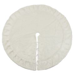 a white round pillow with ruffled edges