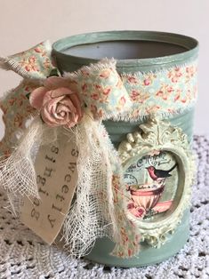 a cup with a tag on it sitting on a doily