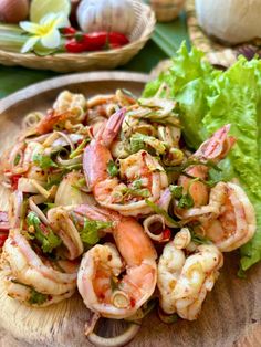 shrimp salad on a plate with lettuce and tomatoes in the backgroud